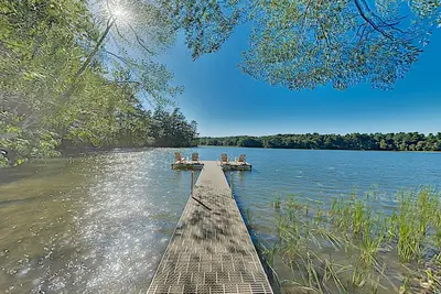 Spacious lakefront home on lush 5-acre lot with sunny deck & private dock