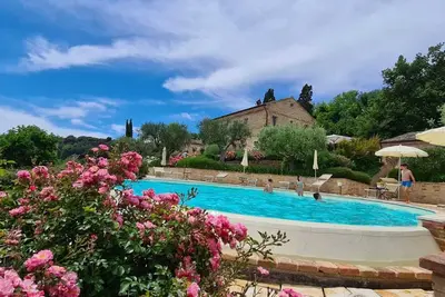 Image de Resort surrounded by greenery arranged for families or groups with an infinity pool.