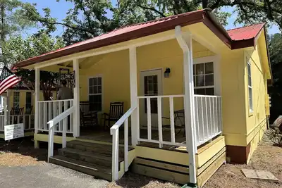 Downtown by Chattahoochee River, sit on front porch as horse and buggy stroll by
