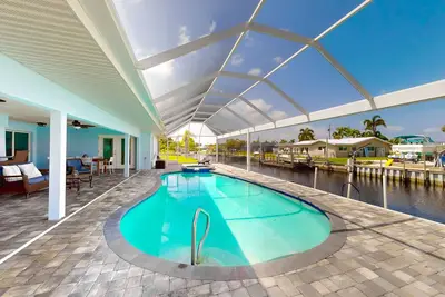 Image de Canal-front home with heated saltwater pool, dock, grill, & covered patio