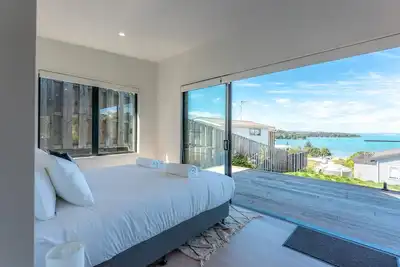 Marama Cottages - Luna Cottage - Located in the heart of Surfdale with outstanding views over the water this brand new 2 bedroom apartment is perfect for family holidays on Waiheke – walking distance to local beaches, off street parking for up to 2 v