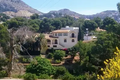 Beautiful villa surrounded by greenery with views of the mountains and the golf course.