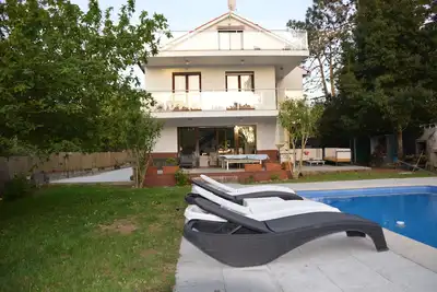 Image de Large house with pool, beach and forest.