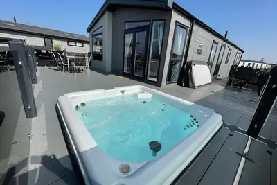 Indulgence Lakeside Lodge i3 is prime location with a private fishing peg and sunken hot tub