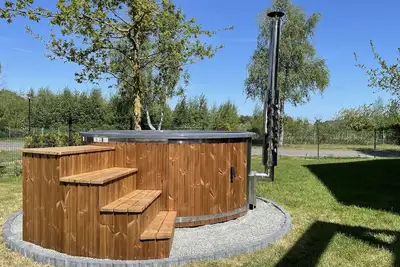 Image de Bright and friendly vacation home with sauna and large garden with whirlpool.