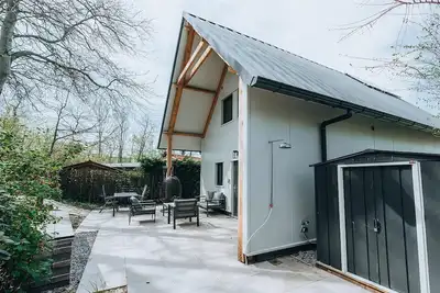 Image de La Folie': a large, elegantly furnished holiday home with plenty of privacy at the back of a green family park.