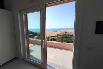 Renovated house overlooking dunes and pristine sea.