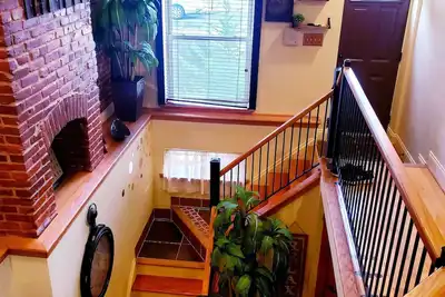 Image de Exclusive Sunken Living Room Soaring Exposed Brick