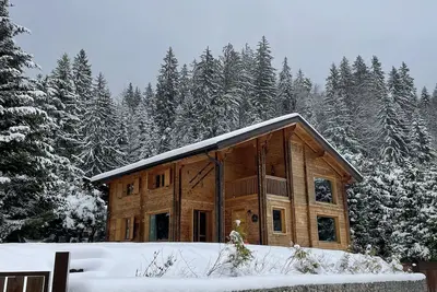 Image de chalet entirely in wood near the center and near the forest