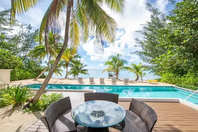 White Cottage: Deluxe Oceanfront Home w/Backyard Beachfront, Private Pool, Dock + Free Kayak