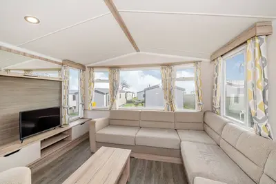Modern and spacious 12ft-wide caravan with one double and two twin.