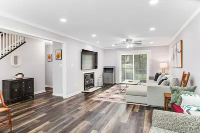Image de 2-story, riverfront home with private dock, inviting deck & dog-friendly yard