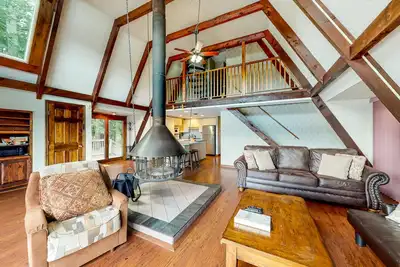Image de Waterfront home with wraparound deck, floating fireplace, deck, & firepit