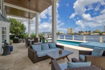 Image de Exquisite waterfront home with a pool, large yard, & grill - close to the beach