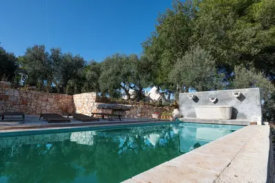 Image de Maison \"Trullo avec piscine partagée\", jardin et terrasse partagés.