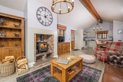 Image de Spacious riverside lodge with mountain views.