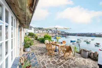 Image de A beautifully refurbished stone cottage that sits right on Mousehole Harbour's waters edge.