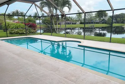 Golf cart distance to Wef! Charming 3 bedroom waterfront home with heated pool.