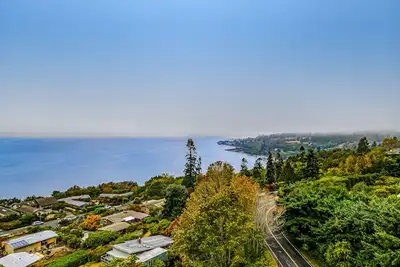 Image de Spectacular mid-century home with two-story fireplace, huge deck, & water views