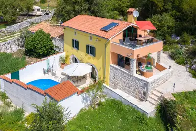 Image de A rustic stone house with pool and sea views.