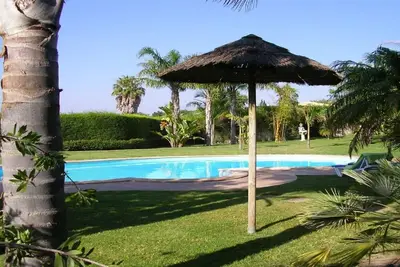 Image de Bungalow with pool, gardens and lake.