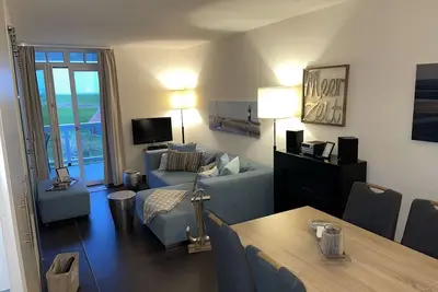 Image de Strandnahe Ferienwohnung mit Sauna, Strandkorb und Balkon mit Land- & Meerblick