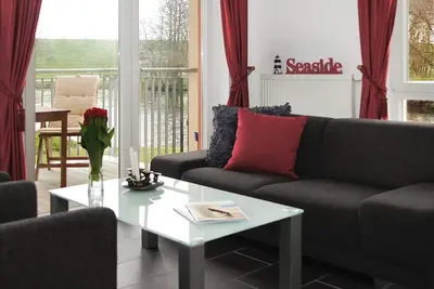 Image de Apartment mit Sauna, Whirlbadewanne und Balkon an der Graft mit Blick zum Deich!