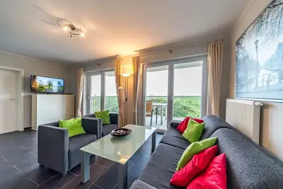 Image de Ferienapartment an der Nordsee mit Tollem Balkon am Wasserlauf und Eigener Sauna