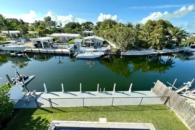 Pristine canal-front home with heated pool and access to open water