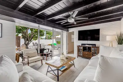 Trendy canal-front home with dock, full kitchen, central Ac, & washer/dryer
