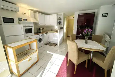 Image de T2 climatisé en rez-de-jardin avec piscine, parking, et terrase. Plage à 450m, WiFi gratuit.