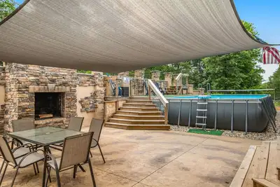 Image de Two-story, dog-friendly home with a pool, indoor/outdoor fireplaces, & Ac