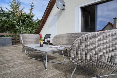 Image de Appartement 'Unteres Apartment Ostseeferienhaus' avec terrasses privées.