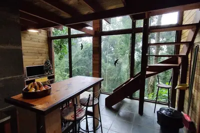 Image de Cozy wooden chalet with glass walls overlooking nature.