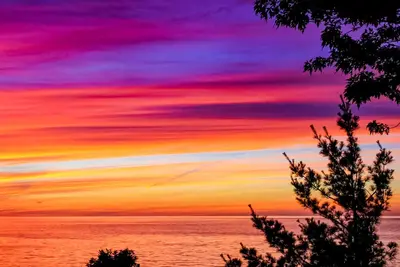 Image de Spacious lakefront home with private beach, hot tub, fire table, & views