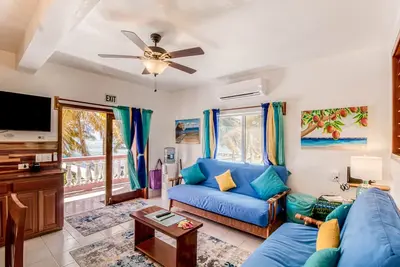 Beachfront condo with beach access, dock, pool, balcony, & ocean views