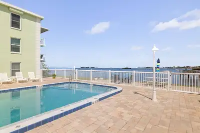 Waterfront Escape! Heated Pool, Bbq, Clubhouse & Pier – Dolphins & Sunsets from Your Private Porch!
