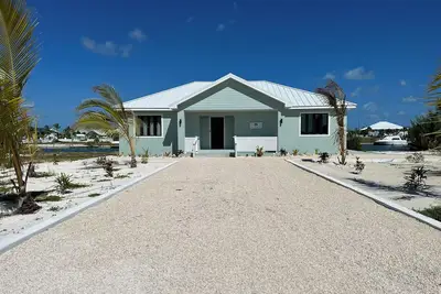 Deep water Canal front home w/ dock across the street from the beach.