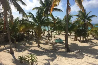 Image de Beachfront views of pristine sandy beach, clear blue waters and surreal sunsets.