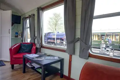 Image de A carefully converted heritage railway coach in the countryside.