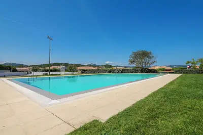 Image de Maison de vacances 'Villetta Palma' avec piscine partagée, terrasse privée et jardin privé