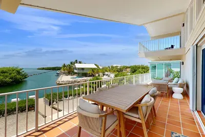 Oceanfront home with a pool, dock, grill, scenic balconies, games, W/D, & Ac