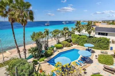 Bonaire Oceanfront 1-bedroom apartment with private terrace and a swimming pool and dive shop onsite.