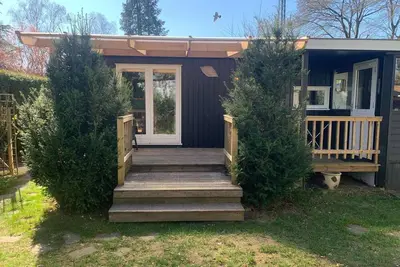 Image de Chalet chaleureux avec véranda et jardin clos, situé dans la région de la Veluwe