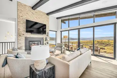 Image de New home with water/mountain views, luxury interior, hot tub, & fireplaces