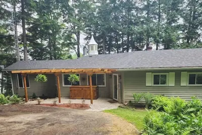 Image de Spacious, waterfront home surrounded by trees with large dock & games room.