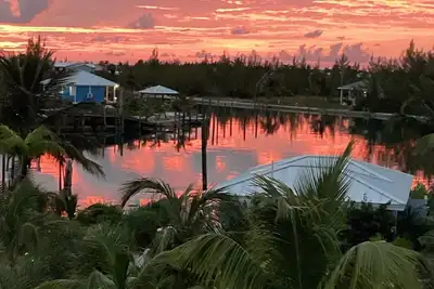 Sunset condo with private deck and dock. Steps away from Windward beach.