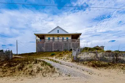 Ocean-view home with wrap-around deck, beach access, outdoor shower & cornhole
