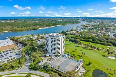 Golf fairway and green view from living room with intracoastal marina next door
