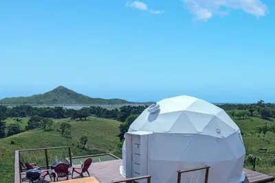 Luxurious Dome set on hillside with views to a lagoon, the ocean and mountains